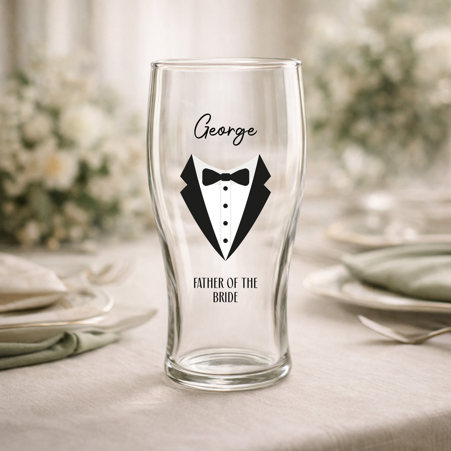 Clear glass with tuxedo design and text on a table setting
