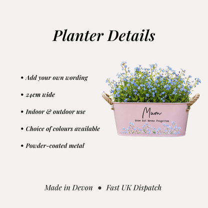 Pink metal planter with flowers and text on a white background