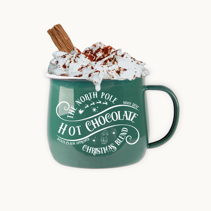 Green mug with 'Hot Chocolate Christmas Blend' text, filled with hot chocolate and whipped cream, on a white background.