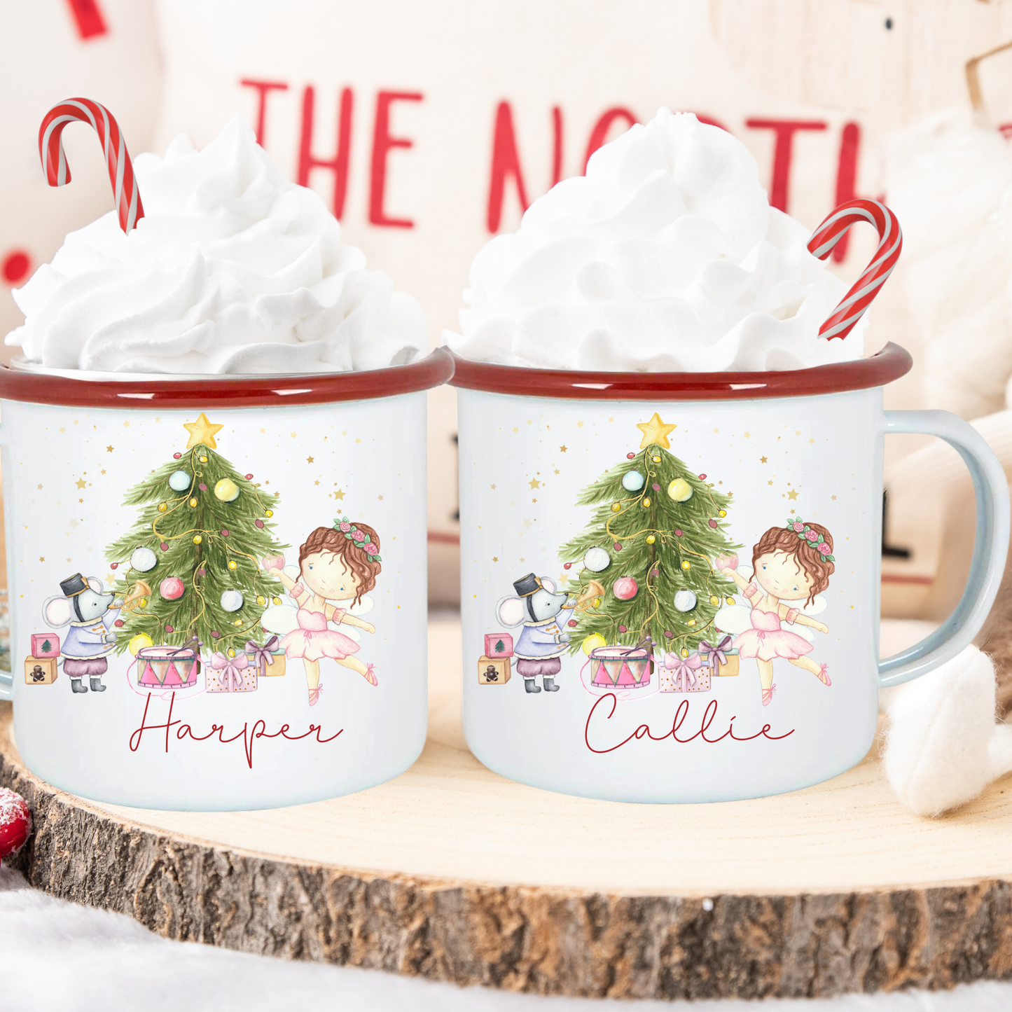 Two mugs with Christmas-themed designs and names 'Harper' and 'Callie' on a wooden surface.