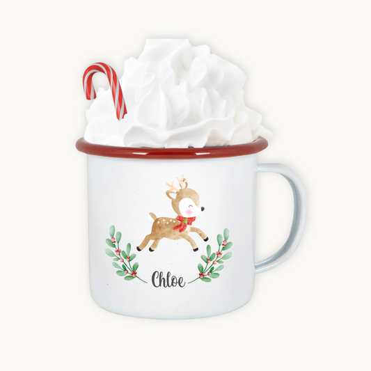 Mug with a reindeer design and candy cane, wrapped in tissue paper on a white background
