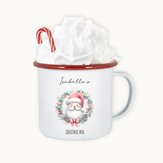Christmas mug with Santa Claus design, candy cane, and gift wrap on a white background