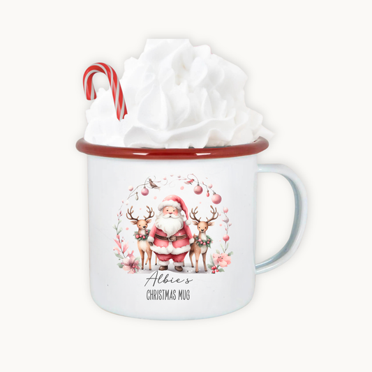 Christmas-themed mug with Santa Claus and reindeer design, featuring a candy cane and gift wrap on a white background.