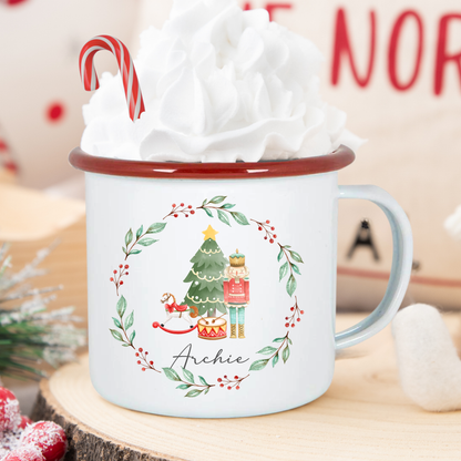 Christmas-themed mug with a tree, presents, and candy cane on a wooden surface.