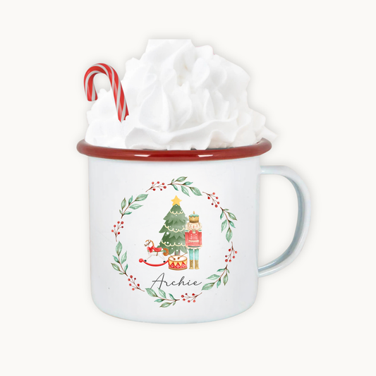 White mug with Christmas design and candy cane, wrapped in tissue paper on a white background