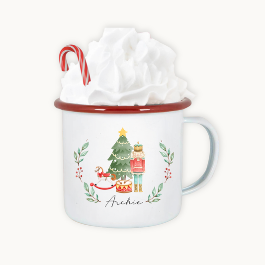 White mug with Christmas design and candy cane, wrapped in tissue paper on a white background