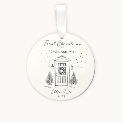Round Christmas ornament with a door and tree design, featuring text 'First Christmas at 4 Mandarin Way' and 'Ellie & Jo 2025'.