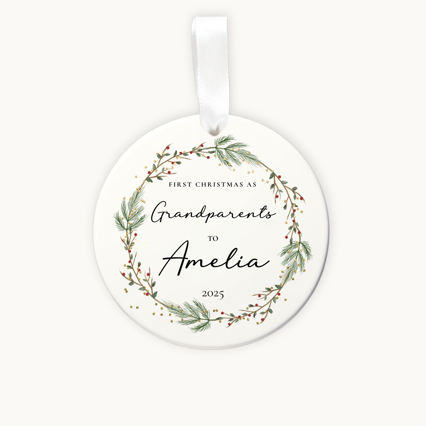 Round ceramic ornament with greenery design and text on a white background