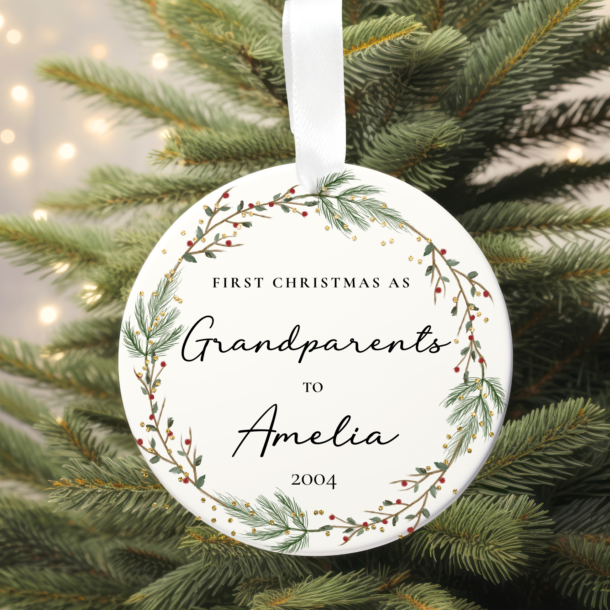 Ornament with 'First Christmas as Grandparents to Amelia 2004' text on a Christmas tree.