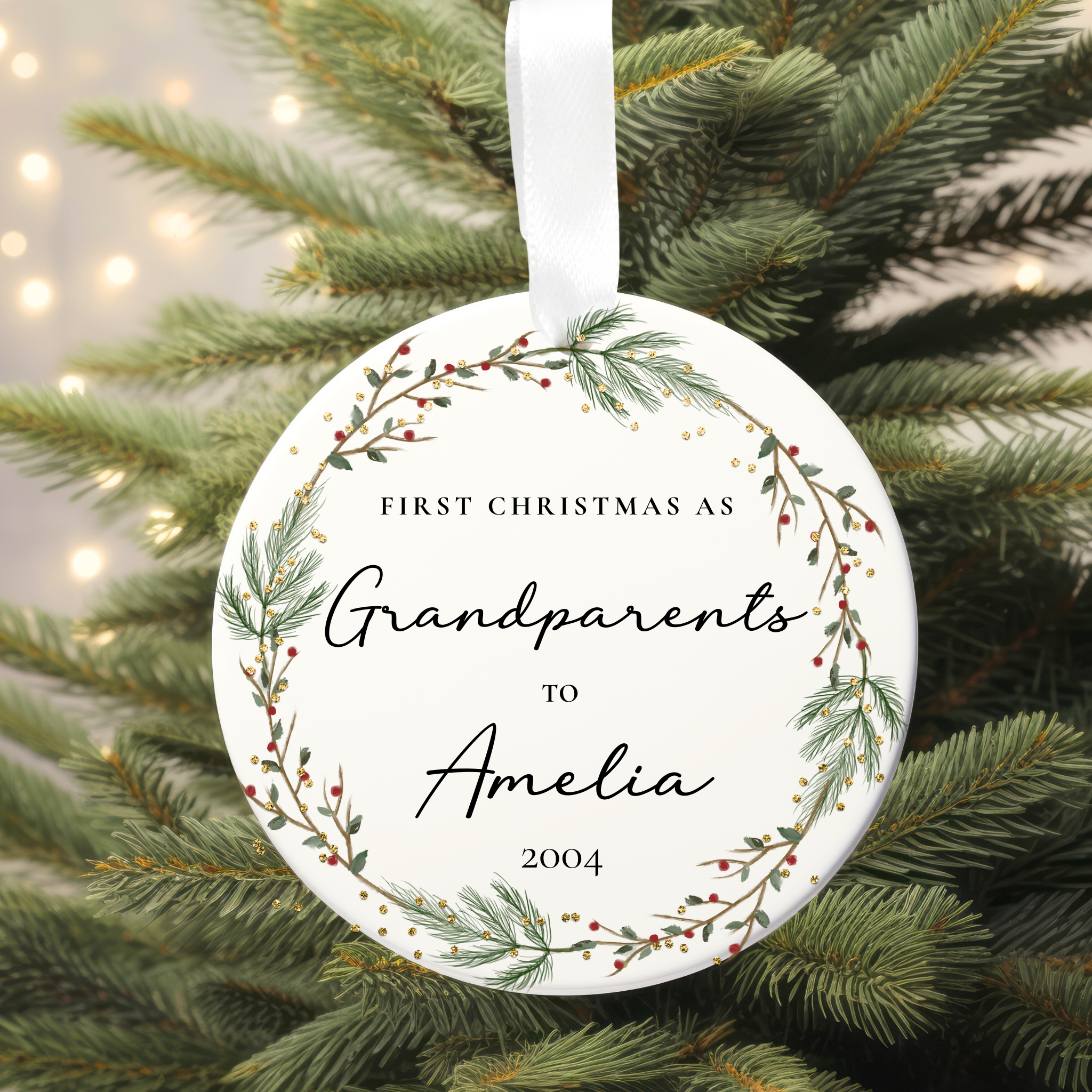 Ornament with 'First Christmas as Grandparents to Amelia 2004' text on a Christmas tree.