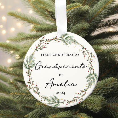 Ornament with 'First Christmas as Grandparents to Amelia 2004' text on a Christmas tree.