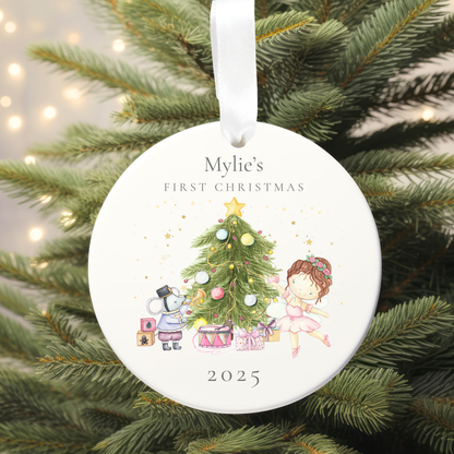 Decorative Christmas ornament with illustrations of a child and a dog by a Christmas tree, hanging on a tree.