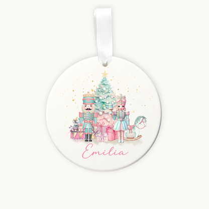 Round Christmas ornament with Nutcracker design and 'Emilia' text on a white background