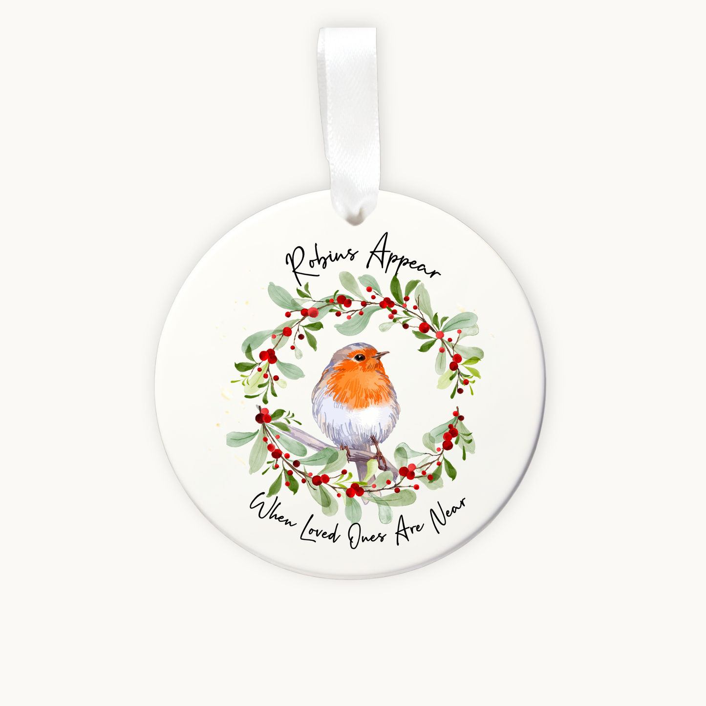 Round ceramic ornament with a robin and mistletoe design on a white background