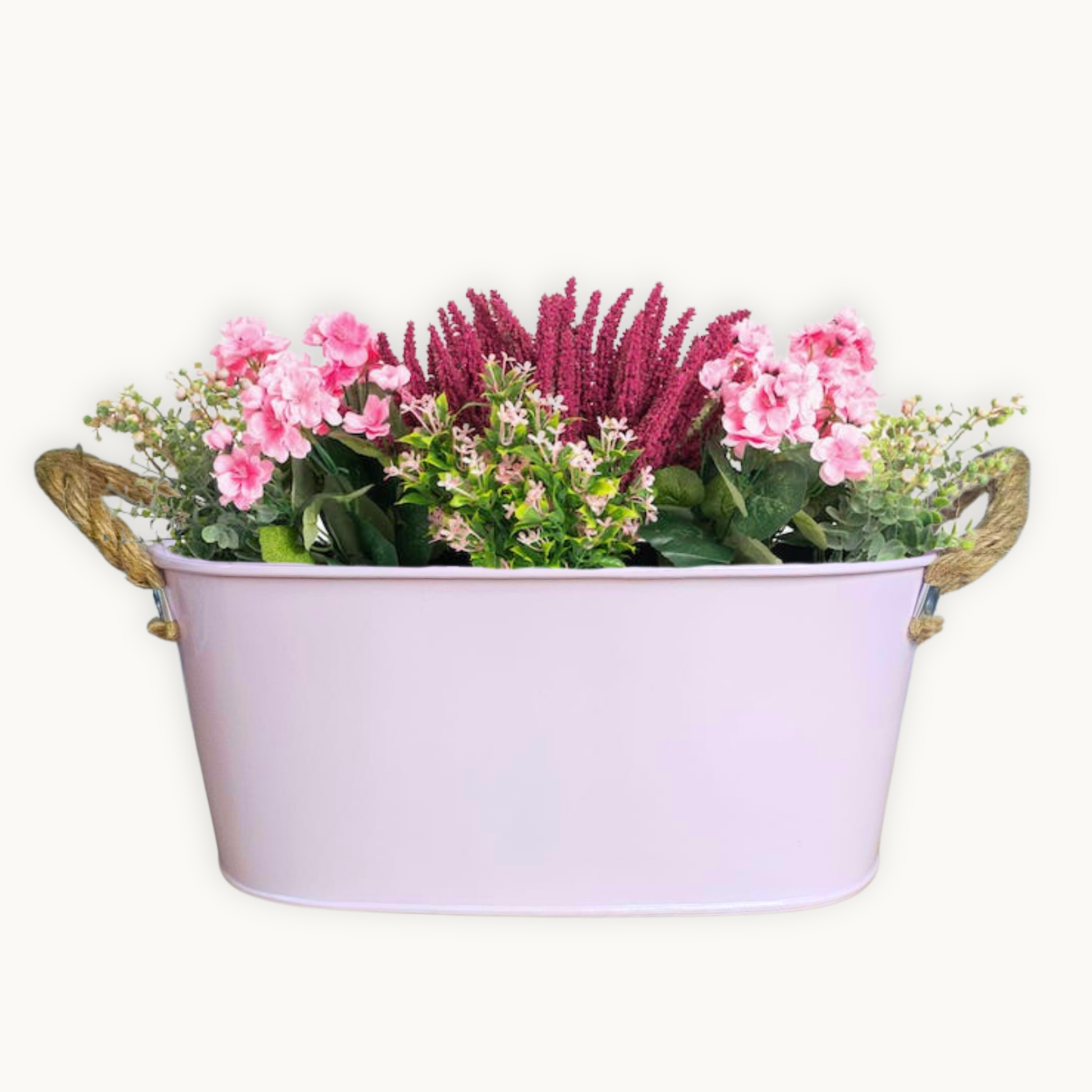 Decorative metal tub filled with flowers on a white background