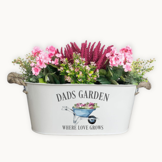 Decorative metal planter with flowers and 'Dad's Garden' text on a white background