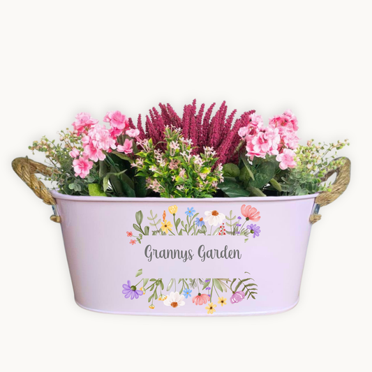 Decorative metal planter with flowers labeled 'Granny's Garden' on a white background