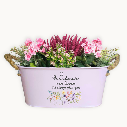 Decorative planter with flowers and a quote on a white background