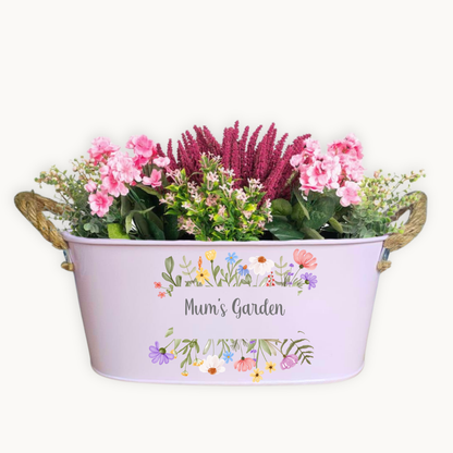 Decorative planter with flowers and 'Mum's Garden' text on a white background