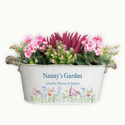 Decorative planter with flowers labeled 'Nanny's Garden' on a white background