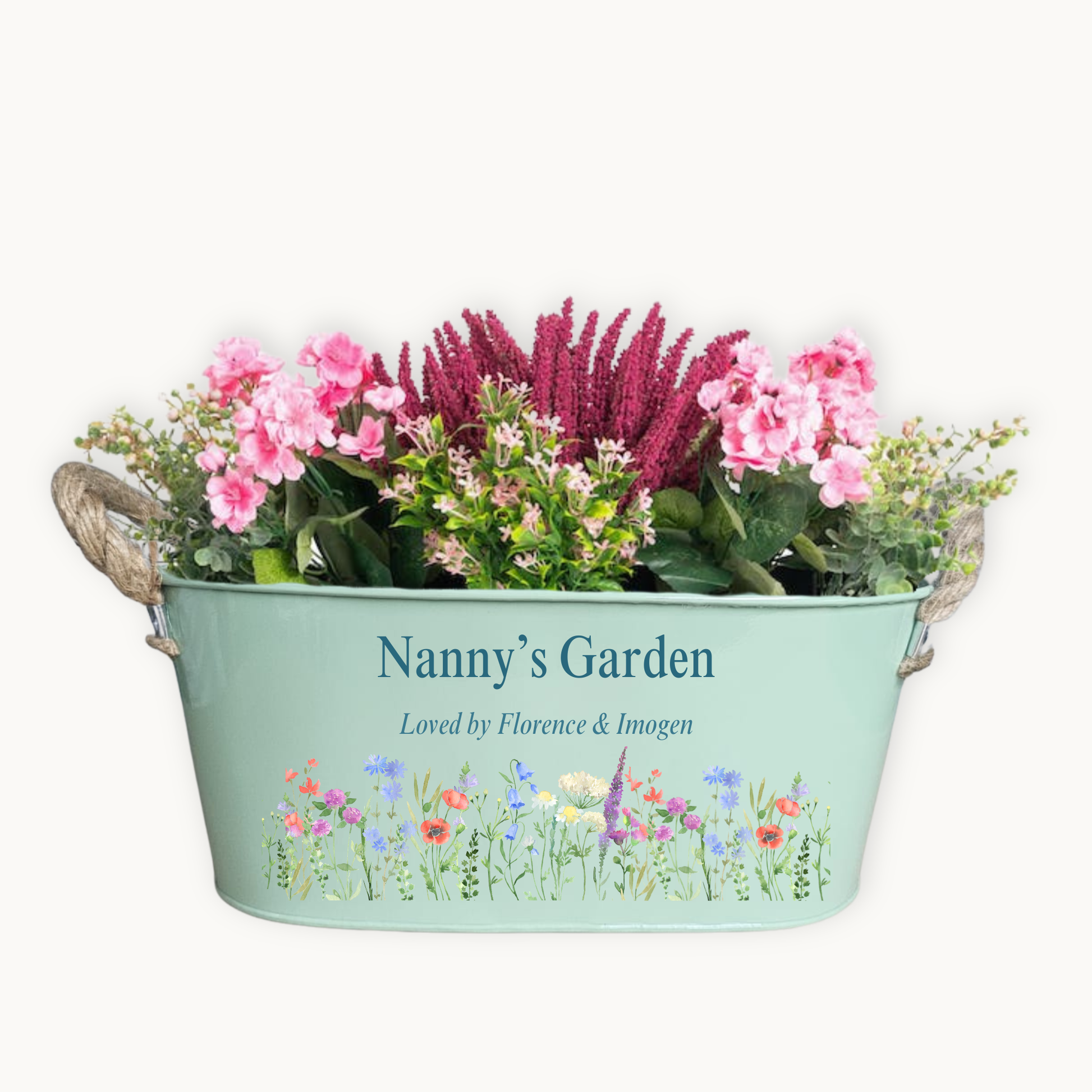 Decorative planter with flowers and 'Nanny's Garden' text on a white background