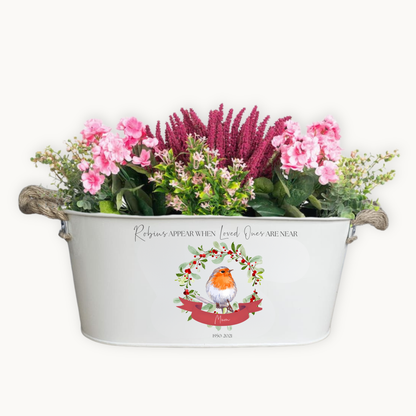Decorative planter with flowers and a robin design on a white background