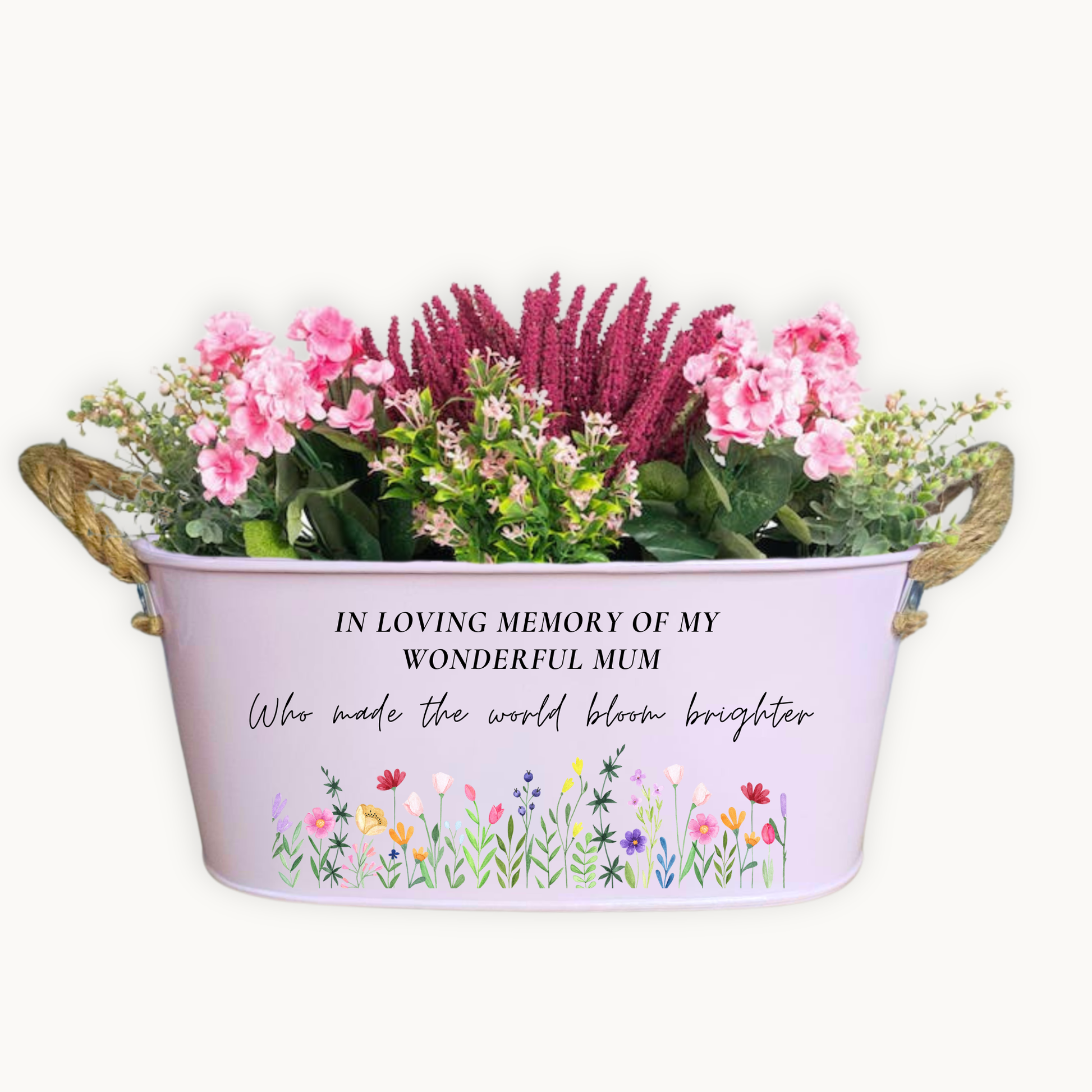 Floral arrangement in a decorative memorial container with a message on a white background
