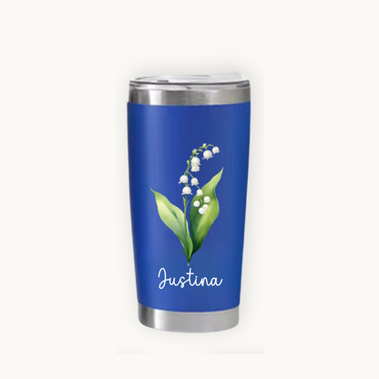 Blue tumbler with floral design and 'Justina' text on a white background