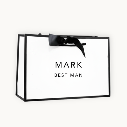 white gift bag with black border and black ribbon printed with the words Mark Best Man