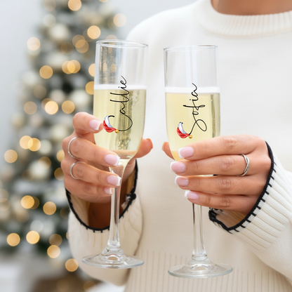 1️⃣ Personalised Christmas prosecco flutes held by woman in festive jumper – Callie Keepsakes
