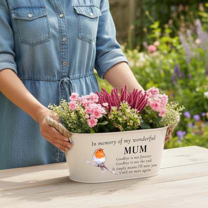 A woman holding Beige memorial planter printed with in memory of my wonderful mum with a robin illustration, with a garden background