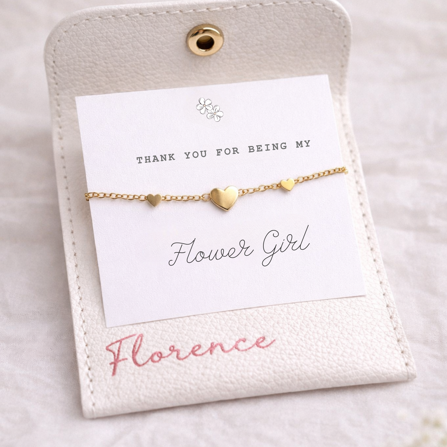 Gold bracelet on a card with 'Thank You For Being My Flower Girl' message on a light background