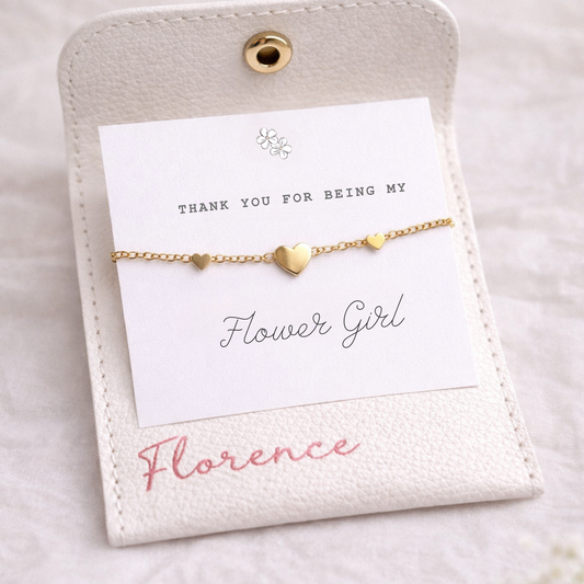 Gold bracelet on a card with 'Thank You For Being My Flower Girl' message on a light background