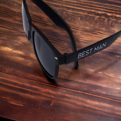 personalised black matte sunglasses printed with best man on dark wooden background
