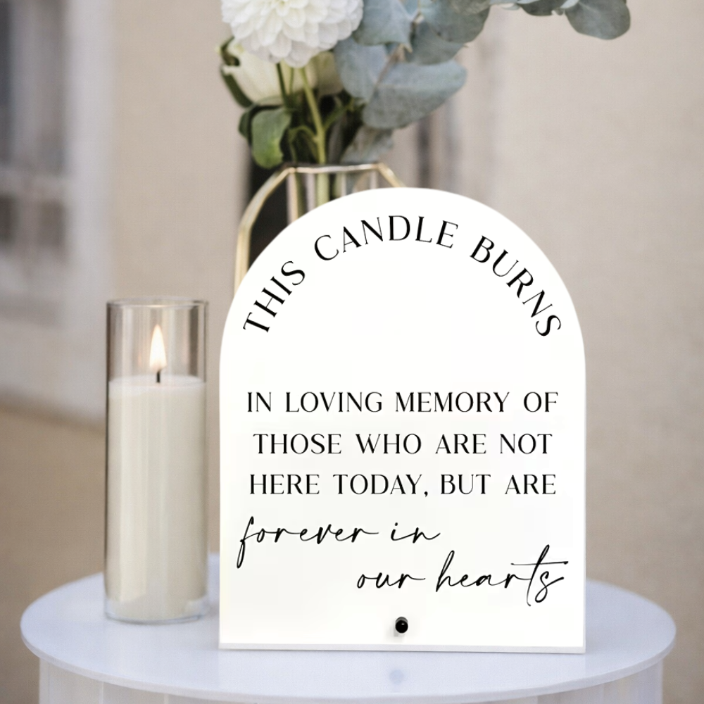 Arched white acrylic memorial sign printed with the words this candle burns in loving memory of those who are not here today but are forever in our hearts