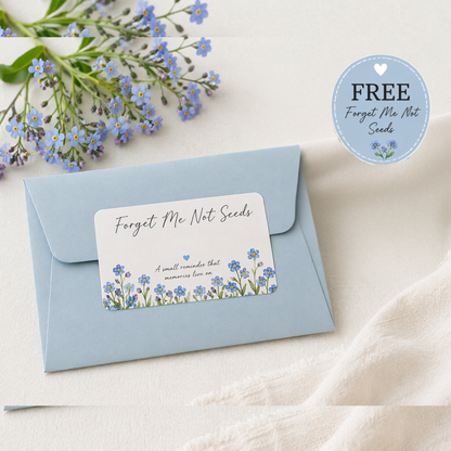Envelope with 'Forget Me Not Seeds' card and forget-me-not flowers on a light background