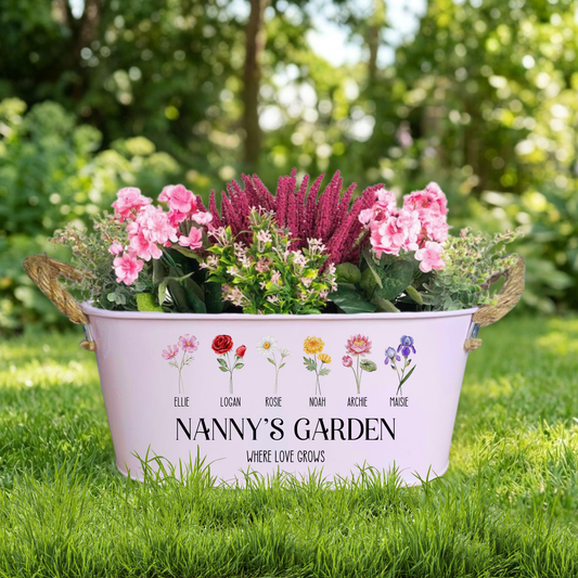 Decorative garden planter with flowers and 'Nanny's Garden' text on a grassy background